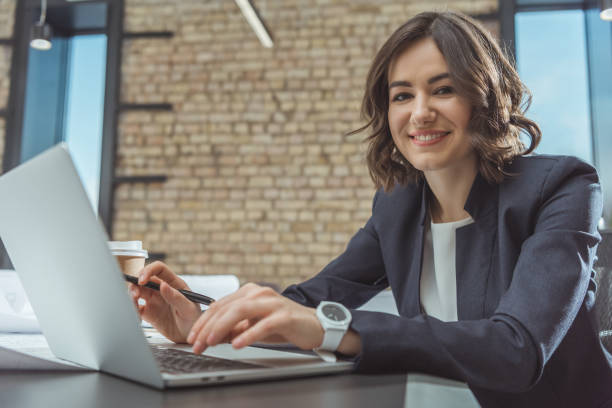 istock beautiful young architect working with laptop and looking at camera 1009467590