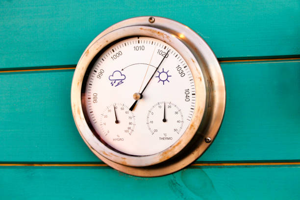 Weather dial Photo of a traditional weather dial on a wall. barometer stock pictures, royalty-free photos & images