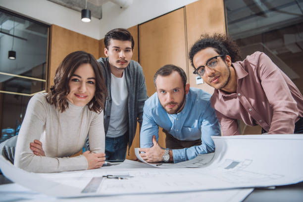 istock group of successful architects working on plans together at office 1009474406