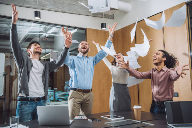 istock group of successful businesspeople throwing up documents at office 1009474582
