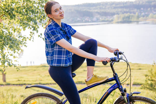 istock Young woman riding a bike 1009474620