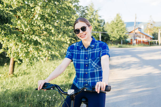 istock Young woman riding a bike 1009474870