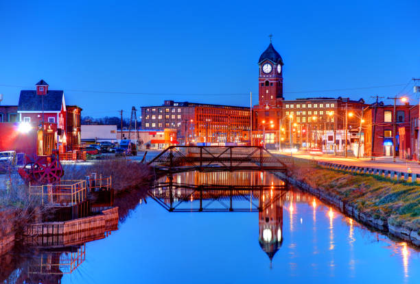 istock Downtown Lawrence clock tower reflecting on a canal 1009482092