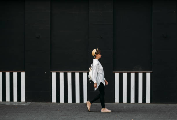 istock Woman in motion near black and white wall. 1009483786