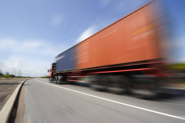 istock Truck on highway road with big container, 1009486742