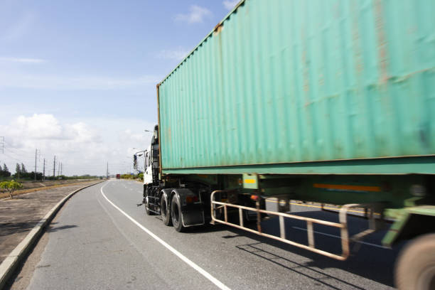 istock Truck on highway road with big container, 1009486748