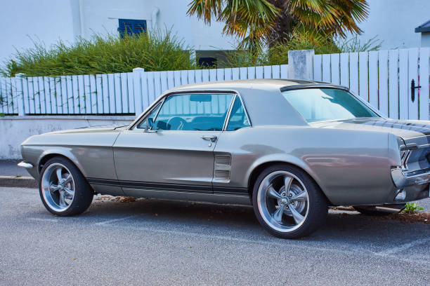 Benodet, France, July 09, 2018: A classic brown Ford Mustang coupe is parking in Benodet, France. Ford mustang is one of the most famous cars in the USA, and is an icon of muscle cars in the world.