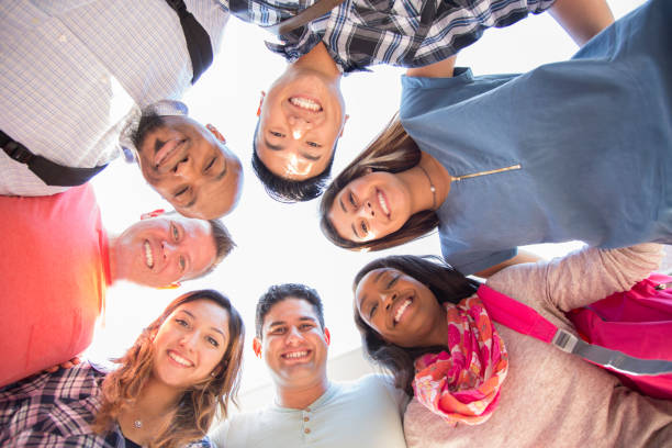 istock College student friends huddle together. 1009499884