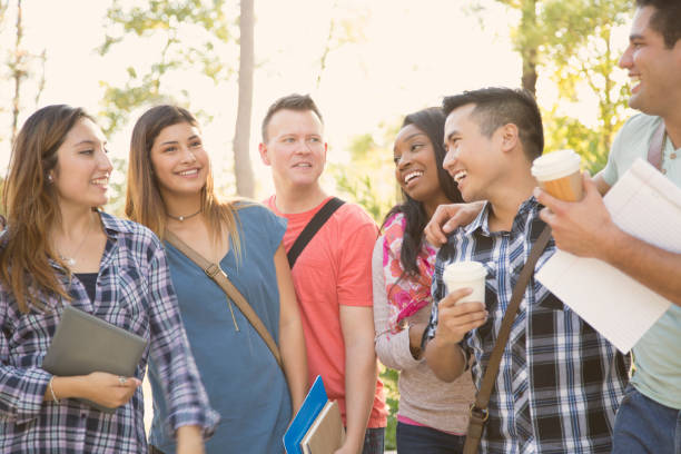 istock College student friends share digital tablet on university campus. 1009501936