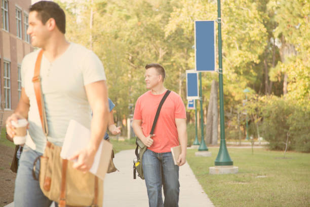 istock College student friends walk together on university campus. 1009501994
