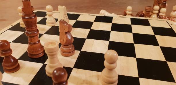 istock How to play wooden board game chess. Improvisation and Different angles of chess sets, pieces and chessboard. White and black figures and board of chess game. 1009504720