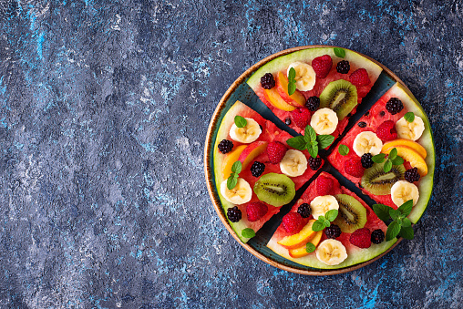Watermelon pizza with fruit and berries. Healthy summer dessert