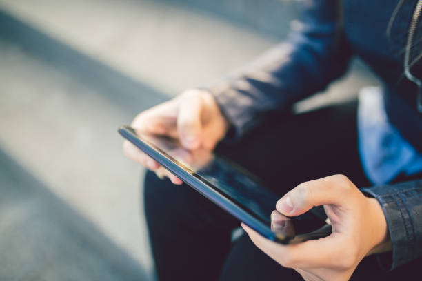istock Hands of young caucasian woman using tablet. Close up. 1009521230