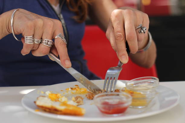 istock Mature woman eating an hamburger 1009529450