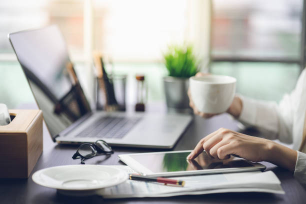istock Businessman relax drinking coffee while working on a document in the office 1009529758