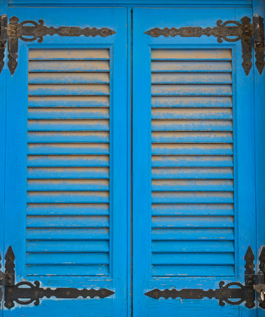 Blue old double-wing sun blind in a vertical format