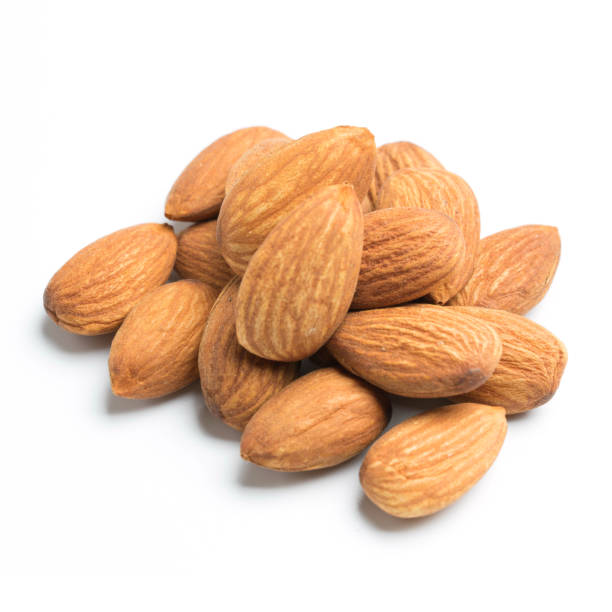 istock closeup of almonds isolated on the white background 1009537980