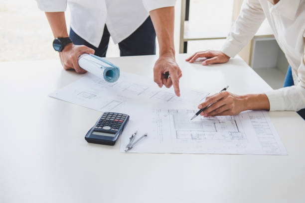 istock Architect or Engineer meeting working with partner on blueprint for architectural project in progress, construction and structure concept 1009541102