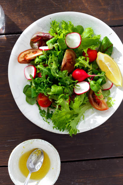 istock Plate fresh vegetable salad with sauce 1009541516