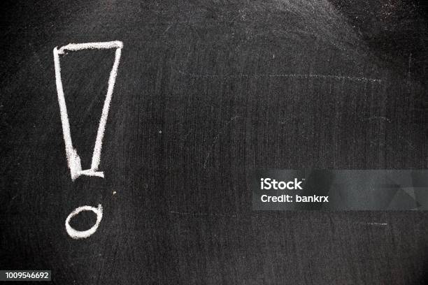 White Color Chalk Hand Drawing In Exclamation Mark With Blank Space Shape On Blackboard Background Stock Photo - Download Image Now