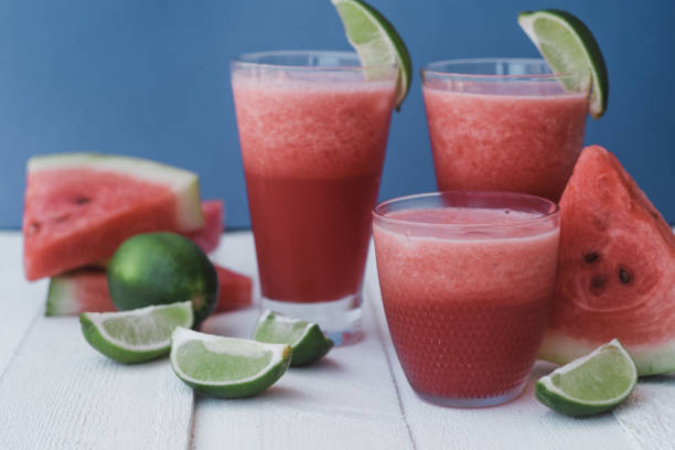 istock Smoothies of fresh watermelon, lime with ice on blue background 1009547752