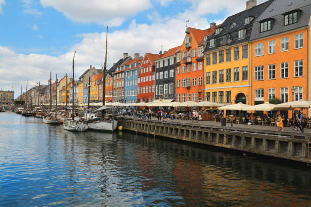 Scenic summer view of Nyhavn pier with color buildings, boats and yachts in the Old Town of Copenhagen, Denmark stock photo