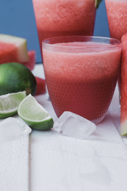 istock Smoothies of fresh watermelon, lime with ice on blue background 1009550130