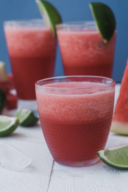 istock Smoothies of fresh watermelon, lime with ice on blue background 1009550430