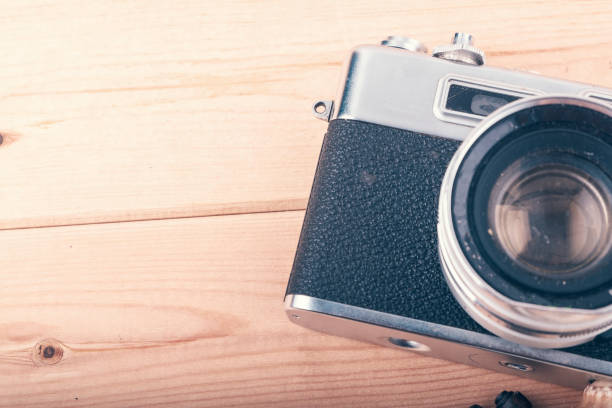 istock film camera on wooden background 1009550556