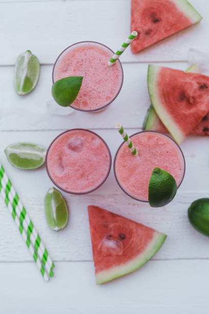 istock Smoothies of fresh watermelon, lime with ice on a white table. Top view 1009551726