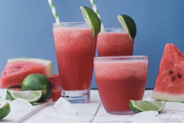 istock Smoothies of fresh watermelon, lime with ice on blue background 1009551846