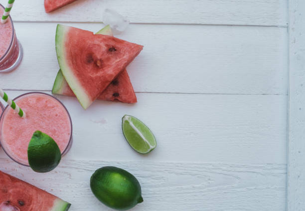 istock Smoothies of fresh watermelon, lime with ice on a white table. Top view, space for text 1009554136