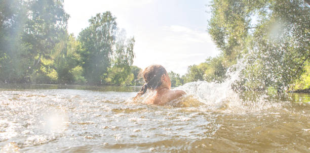 istock Girl playing in the water. 1009554256
