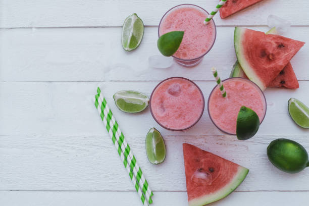 istock Smoothies of fresh watermelon, lime with ice on a white table. Top view, space for text 1009555278