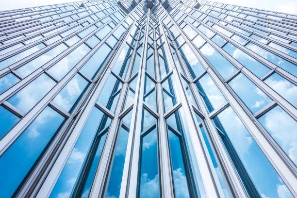 istock underside panoramic and perspective view to steel blue glass high rise building skyscrapers, business concept of successful industrial architecture 1009557924