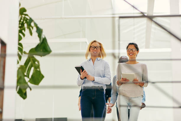 istock Smiling diverse businesspeople walking together in an office 1009561960