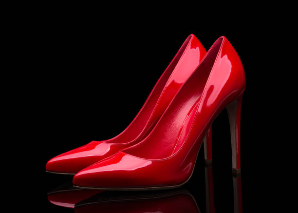 istock Red high heeled shoes and black background 1009564574