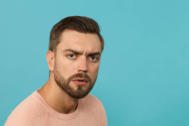 istock studio portrait of an attractive 30 year old man with a beard on a blue background 1009565174