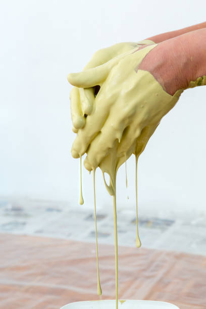 istock woman hands mixing paint, human home activity, color dripping down 1009573926