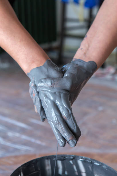 istock woman hands mixing paint, human home activity, color dripping down 1009574126