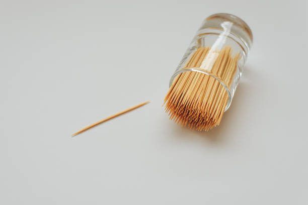 istock Toothpicks made of wood in a glass container on a white background 1009578032