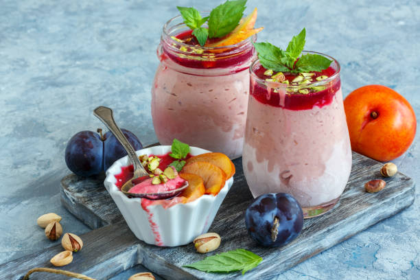 istock Jars with homemade plum ice cream and mint sprigs. 1009584684