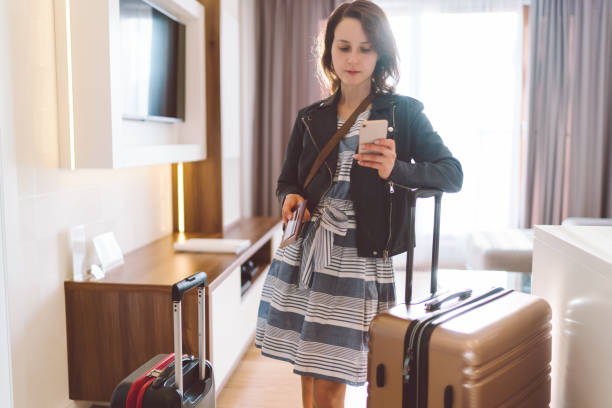 istock Tourist in hotel room calling a taxi 1009600932