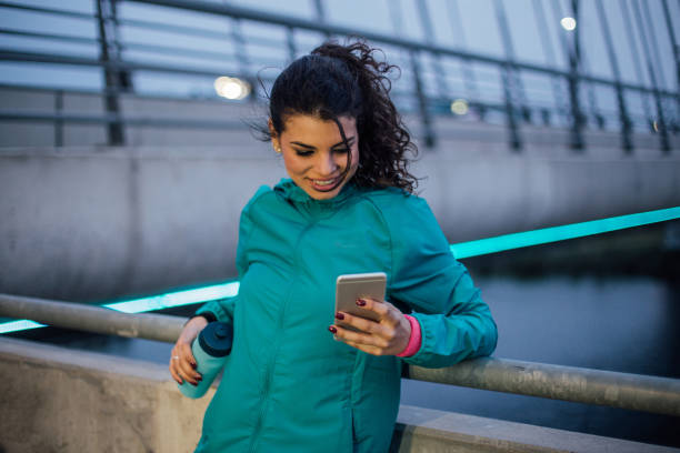 istock Young girl text messaging after outdoor exercise 1009604054