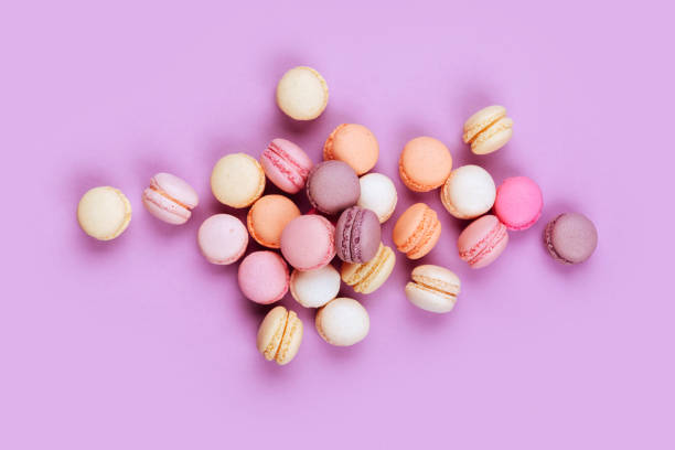istock Sweet french macarons on pink background. 1009611270