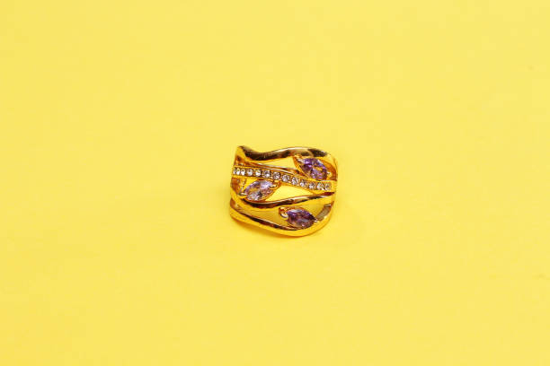 istock gold ring isolated on yellow background 1009611566