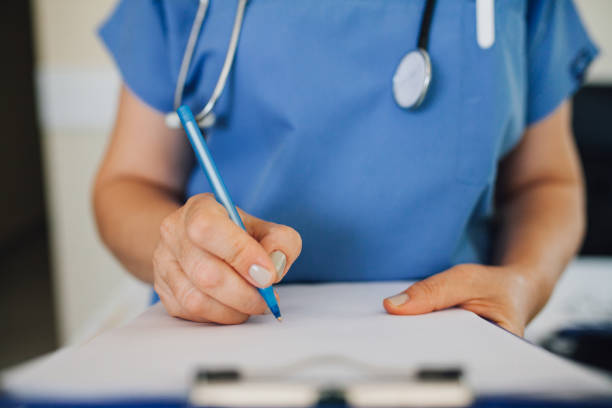 istock Hand of a doctor writing 1009612692