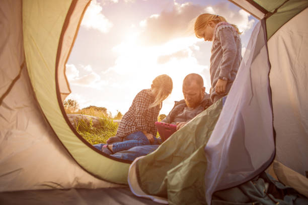 istock Redhead father and blonde daughters on a sunny spring camping trip 1009619746