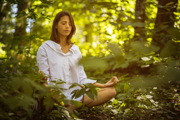 istock Yoga in forest. Young women. 1009625916
