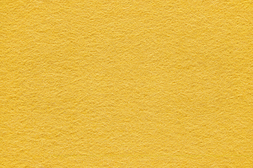 Yellow felt surface extreme close up. Large macro texture and background